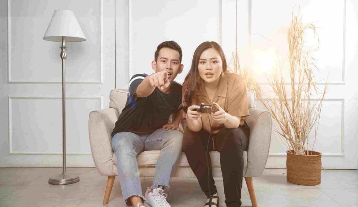 Couple Playing Video Games The couple is enjoying quarantine while playing video games.